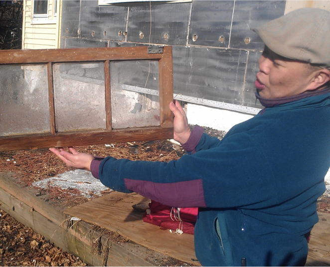 man holding a salvaged window